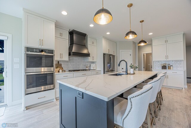 3340 2nd St E, West Fargo, ND 58078 - kitchen featuring stainless steel appliances, custom range hood, a sink, tasteful backsplash, and light stone countertops