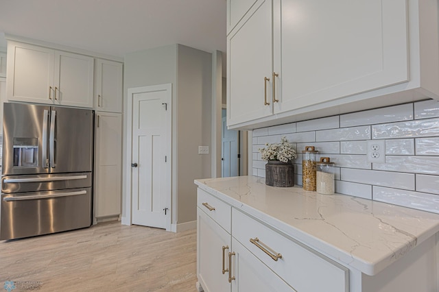 3340 2nd St E, West Fargo, ND 58078 - kitchen featuring stainless steel fridge, decorative backsplash, light wood-type flooring, light stone countertops, and white cabinets