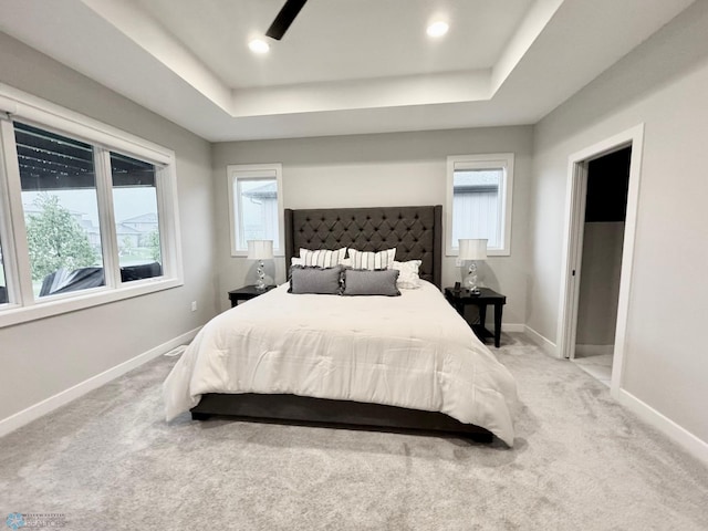 3340 2nd St E, West Fargo, ND 58078 - bedroom featuring a tray ceiling, light colored carpet, multiple windows, and recessed lighting