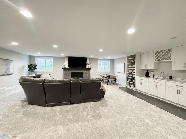 3340 2nd St E, West Fargo, ND 58078 - living area featuring recessed lighting, dark carpet, a fireplace, wet bar, and baseboards