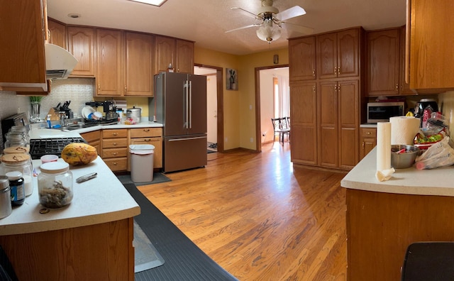 1272 Burke Ave E, Maplewood, MN 55109 - kitchen with stainless steel appliances, a ceiling fan, light wood-style flooring, and light countertops