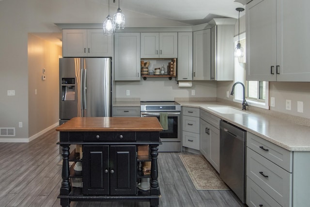 7903 Long Lake Bay Rd, Brainerd, MN 56401 - kitchen featuring stainless steel appliances, open shelves, a sink, wood finished floors, and lofted ceiling