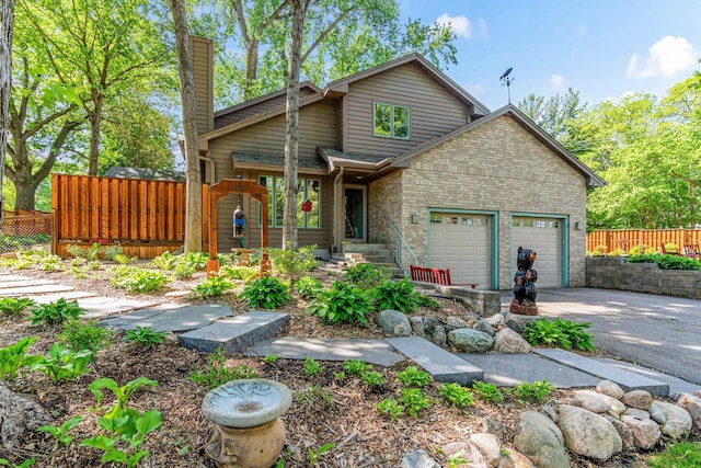 2195 Bayview Pl, Orono, MN 55391 - view of front of home featuring brick siding, driveway, a chimney, and a garage