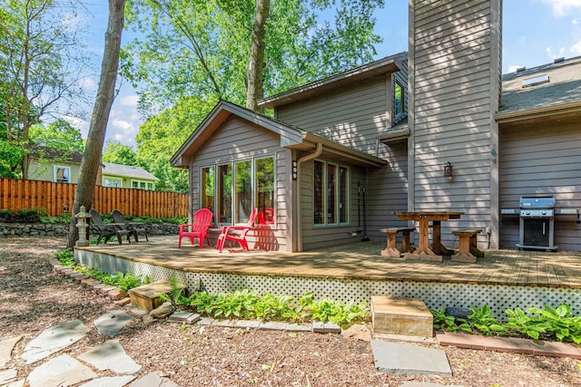 2195 Bayview Pl, Orono, MN 55391 - back of property featuring a chimney, a wooden deck, and outdoor dining space