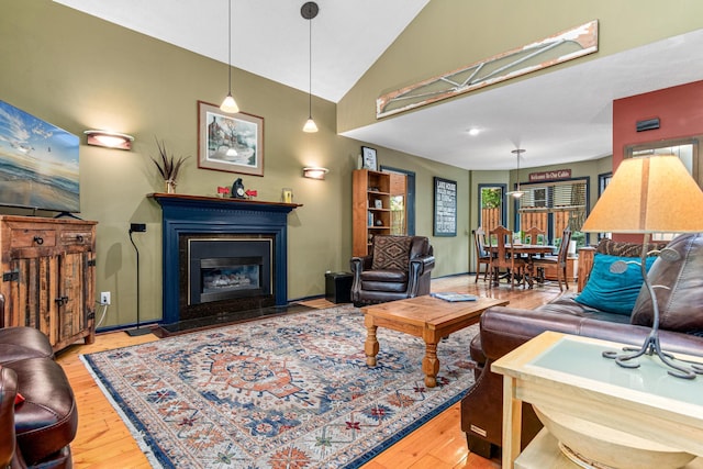2195 Bayview Pl, Orono, MN 55391 - living room featuring wood finished floors, a glass covered fireplace, and high vaulted ceiling