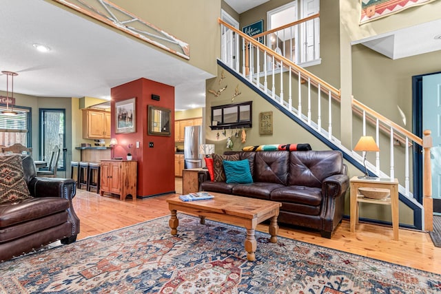 2195 Bayview Pl, Orono, MN 55391 - living room featuring light wood-style flooring, plenty of natural light, and stairway