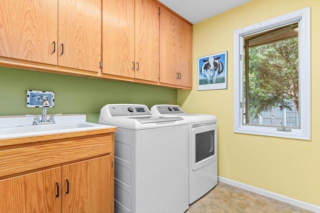2195 Bayview Pl, Orono, MN 55391 - laundry area featuring separate washer and dryer, cabinet space, and baseboards