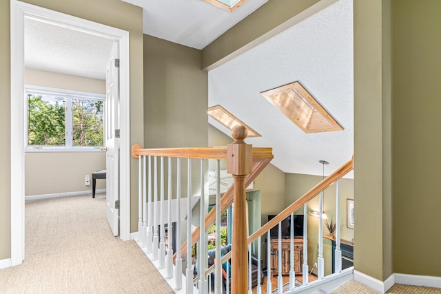 2195 Bayview Pl, Orono, MN 55391 - hallway featuring carpet flooring, an upstairs landing, baseboards, and a skylight