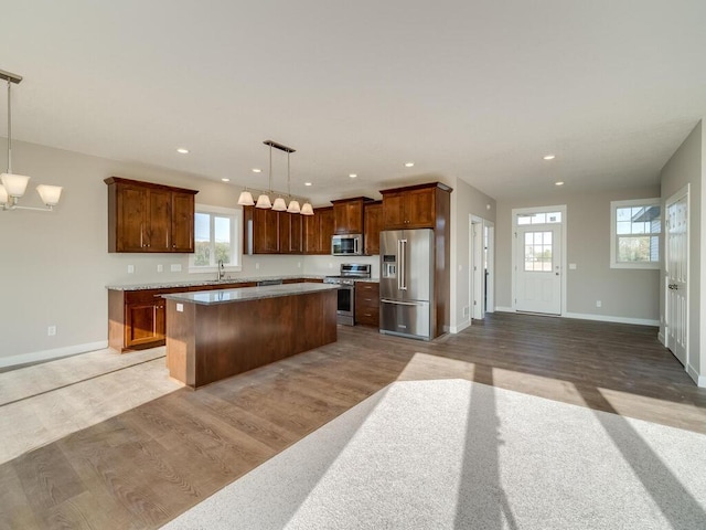 967 206th Ave NW, Oak Grove, MN 55011 - kitchen with appliances with stainless steel finishes, a kitchen island, wood finished floors, baseboards, and recessed lighting
