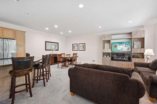 2658 133rd St W, Rosemount, MN 55068 - living room with recessed lighting, light colored carpet, and a glass covered fireplace