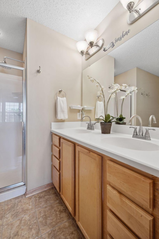 2658 133rd St W, Rosemount, MN 55068 - bathroom with a textured ceiling, double vanity, and a stall shower