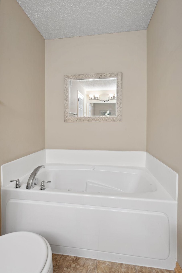 2658 133rd St W, Rosemount, MN 55068 - full bath featuring toilet, a garden tub, a textured ceiling, and tile patterned floors