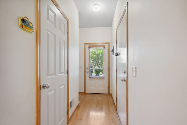 2658 133rd St W, Rosemount, MN 55068 - entryway featuring light wood-style flooring, baseboards, and a textured ceiling