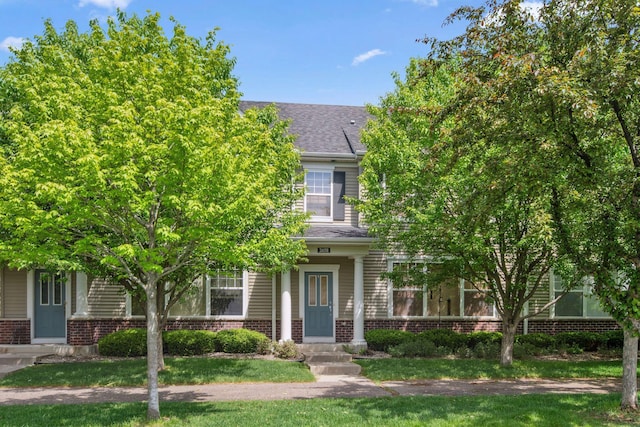 2658 133rd St W, Rosemount, MN 55068 - view of property hidden behind natural elements featuring brick siding, a front lawn, and roof with shingles