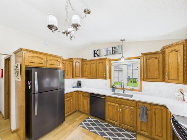 625 7th St NW, Richmond, MN 56368 - kitchen with stainless steel appliances, a sink, light wood-style floors, lofted ceiling, and brown cabinetry