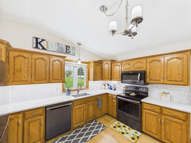625 7th St NW, Richmond, MN 56368 - kitchen featuring appliances with stainless steel finishes, a sink, vaulted ceiling, and brown cabinets