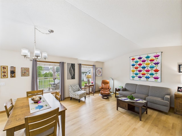 625 7th St NW, Richmond, MN 56368 - living area with lofted ceiling, a chandelier, and light wood-type flooring