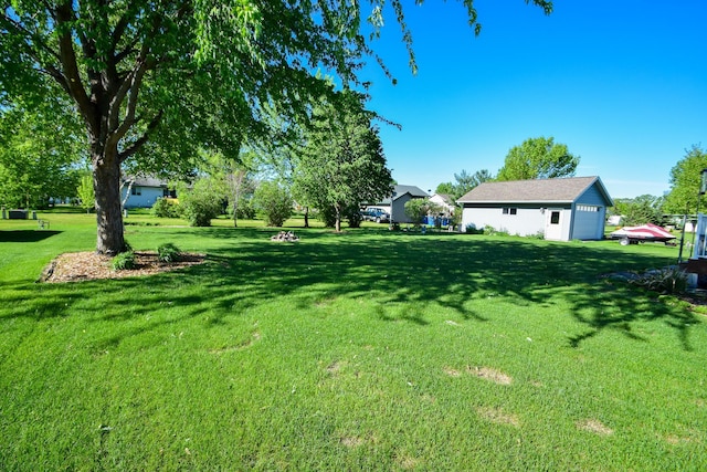 625 7th St NW, Richmond, MN 56368 - view of grassy yard with a detached garage