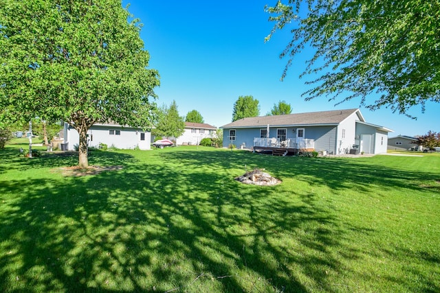625 7th St NW, Richmond, MN 56368 - view of green lawn featuring a deck and an outdoor fire pit