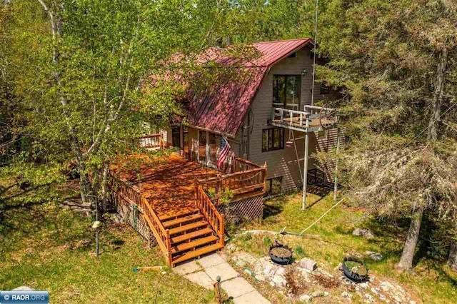 3240 Breezy Point Rd, Tower, MN 55790 - view of home's exterior featuring metal roof, a deck, and stairway
