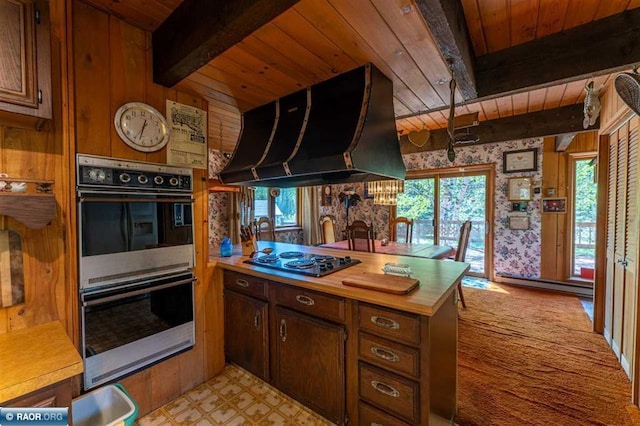 3240 Breezy Point Rd, Tower, MN 55790 - kitchen featuring multiple ovens, wood ceiling with exposed beams, exhaust hood, healthy amount of natural light, and black electric stovetop