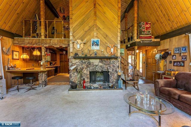 3240 Breezy Point Rd, Tower, MN 55790 - living area with high vaulted ceiling, wood walls, wood ceiling with exposed beams, carpet floors, and a fireplace