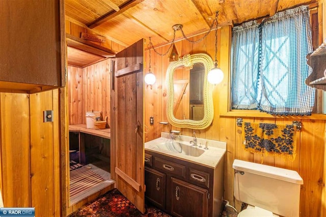 3240 Breezy Point Rd, Tower, MN 55790 - bathroom featuring wooden ceiling, wooden walls, vanity, and toilet