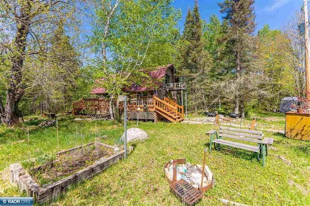 3240 Breezy Point Rd, Tower, MN 55790 - view of green lawn featuring a wooden deck and a garden