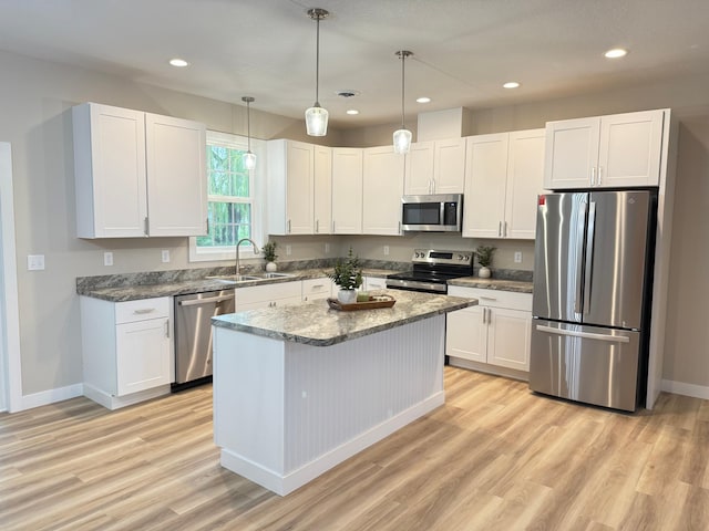 105 7th St, Hoffman, MN 56339 - kitchen featuring appliances with stainless steel finishes, a sink, light wood-style floors, white cabinets, and recessed lighting