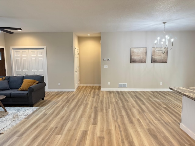 105 7th St, Hoffman, MN 56339 - living room with light wood-type flooring, a chandelier, baseboards, a ceiling fan, and recessed lighting