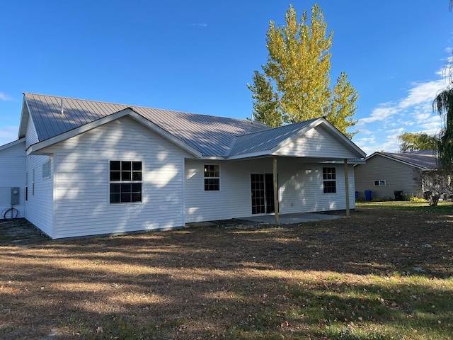 105 7th St, Hoffman, MN 56339 - back of house with metal roof, a patio, and a lawn