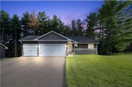 316 Evergreen Dr, Somerset, WI 54025 - ranch-style house featuring driveway, a front lawn, and a garage