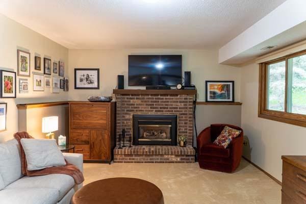 9826 Brighton Ln, Eden Prairie, MN 55347 - living room featuring a brick fireplace and carpet flooring