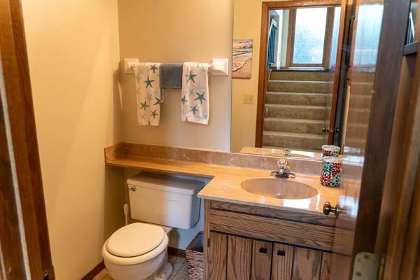 9826 Brighton Ln, Eden Prairie, MN 55347 - half bathroom with vanity and tile patterned flooring