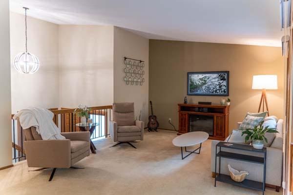 9826 Brighton Ln, Eden Prairie, MN 55347 - sitting room with a chandelier, carpet floors, and a glass covered fireplace