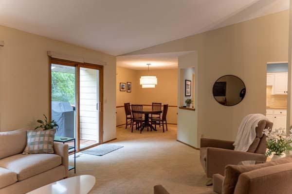 9826 Brighton Ln, Eden Prairie, MN 55347 - living area featuring light colored carpet, vaulted ceiling, and plenty of natural light