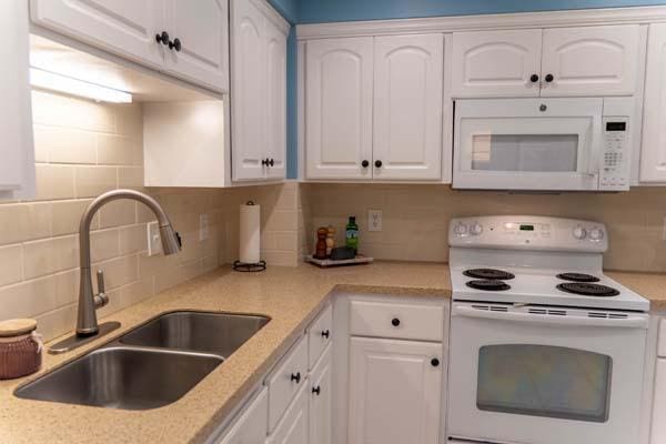 9826 Brighton Ln, Eden Prairie, MN 55347 - kitchen featuring white appliances and white cabinetry