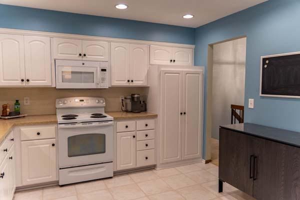 9826 Brighton Ln, Eden Prairie, MN 55347 - kitchen with white appliances, white cabinetry, light countertops, and recessed lighting