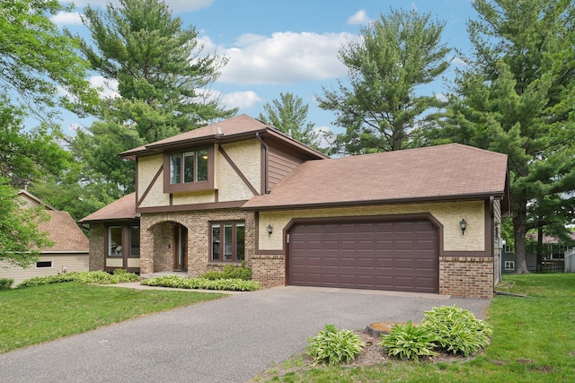 669 Lake Pine Dr, Shoreview, MN 55126 - english style home with driveway, brick siding, an attached garage, and a front yard