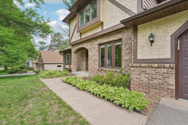 669 Lake Pine Dr, Shoreview, MN 55126 - doorway to property featuring brick siding and a yard