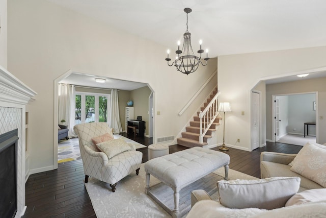 669 Lake Pine Dr, Shoreview, MN 55126 - living room featuring a chandelier, a tiled fireplace, baseboards, dark wood finished floors, and stairs