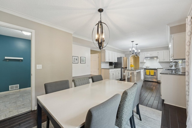 669 Lake Pine Dr, Shoreview, MN 55126 - dining room with a chandelier, dark wood finished floors, ornamental molding, and baseboards