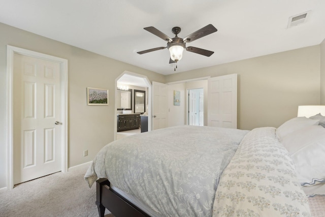 669 Lake Pine Dr, Shoreview, MN 55126 - carpeted bedroom with arched walkways, baseboards, a ceiling fan, and ensuite bathroom