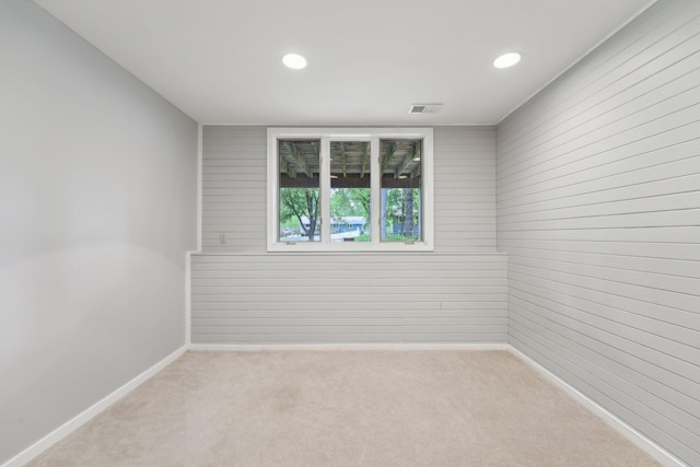 669 Lake Pine Dr, Shoreview, MN 55126 - unfurnished room with carpet floors, wood walls, recessed lighting, and baseboards