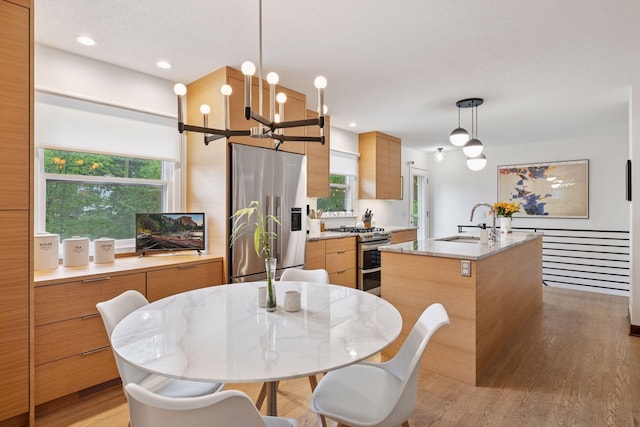 18201 Kathleene Dr, Minnetonka, MN 55345 - kitchen with stainless steel appliances, modern cabinets, a sink, and an island with sink