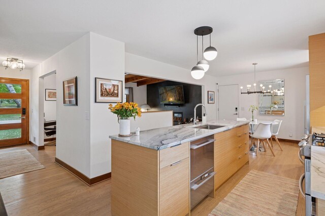 18201 Kathleene Dr, Minnetonka, MN 55345 - kitchen featuring a chandelier, a sink, modern cabinets, and light wood-type flooring