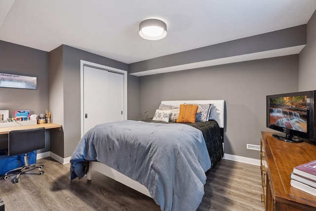 18201 Kathleene Dr, Minnetonka, MN 55345 - bedroom featuring wood finished floors, baseboards, an office area, and a closet