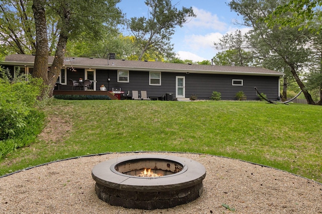18201 Kathleene Dr, Minnetonka, MN 55345 - rear view of property featuring a fire pit, a yard, and a deck
