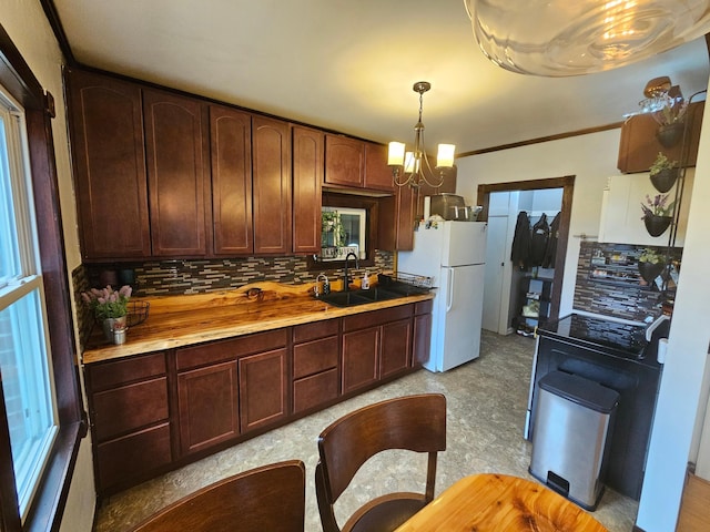 205 2nd Ave W, Lamberton, MN 56152 - kitchen with freestanding refrigerator, tasteful backsplash, a sink, a chandelier, and crown molding