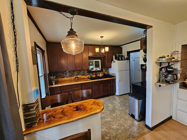 205 2nd Ave W, Lamberton, MN 56152 - kitchen with freestanding refrigerator, backsplash, and dark brown cabinets